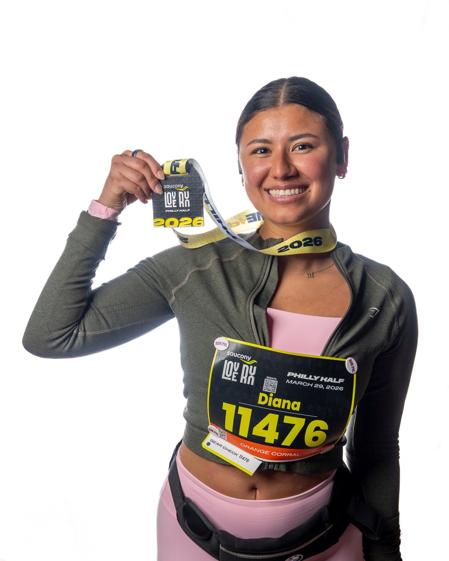 Diana Sparkles holding her race medal, smiling